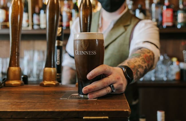 Hand around a freshly poured pint of Guinness at Paddy McNaughton's, Christchurch.