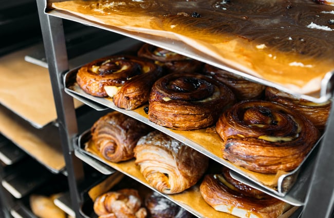 Close up of freshly baked pastries sitting on cooling racks at Pembroke Pâtisserie.