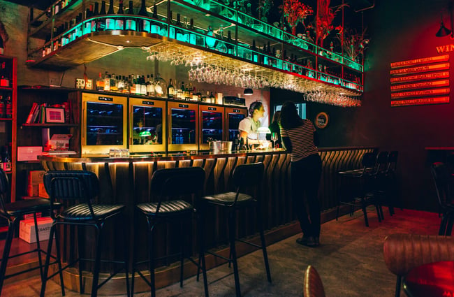 Long bar with colourful mood lighting.