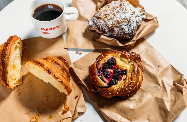 A close up of pastries and coffee on a table.