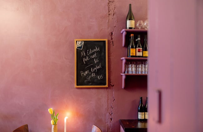 A little chalkboard menu on a purple wall.