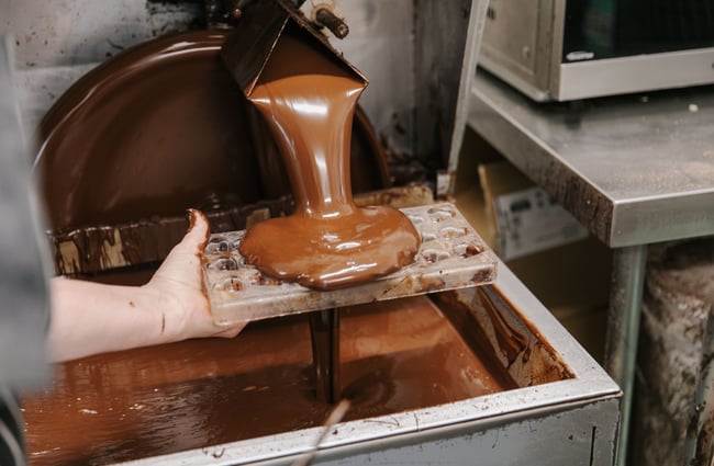 Melted chocolate coming out of machinery at Seriously Good Chocolate Company.