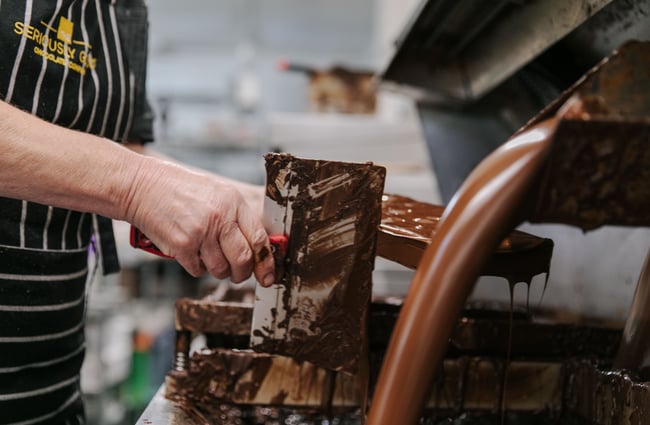 Woman making a block of chocolate at Seriously Good Chocolate Company.
