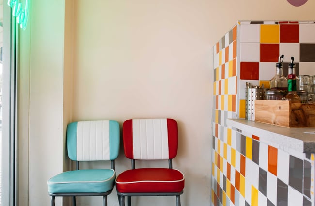 Retro chairs in the waiting area next to a funky tiled counter.