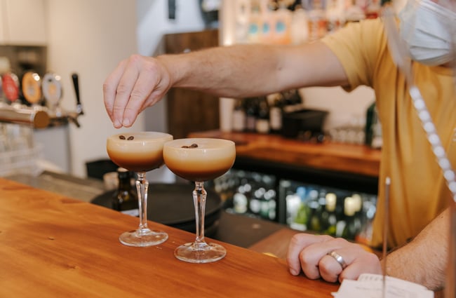 Putting coffee beans on espresso martinis at Sumner Social, Christchurch.