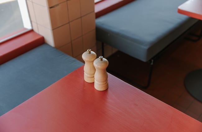 A close up of salt and pepper shakers on a table.