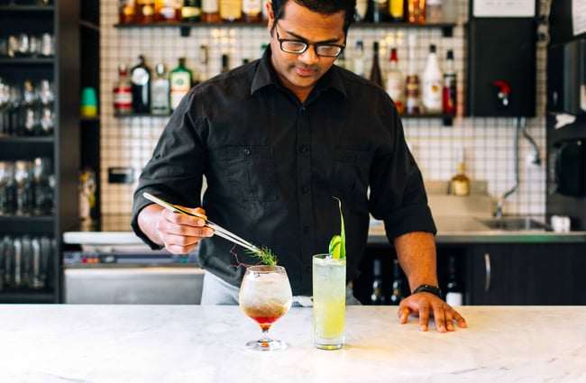 A man preparing cocktails.