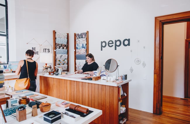 A staff member working at Pepa Stationery inside the Christchurch Arts Centre.