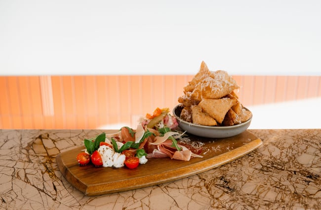 Italian salad with pizza fritti on a wooden platter on the bar at The Birdwood.