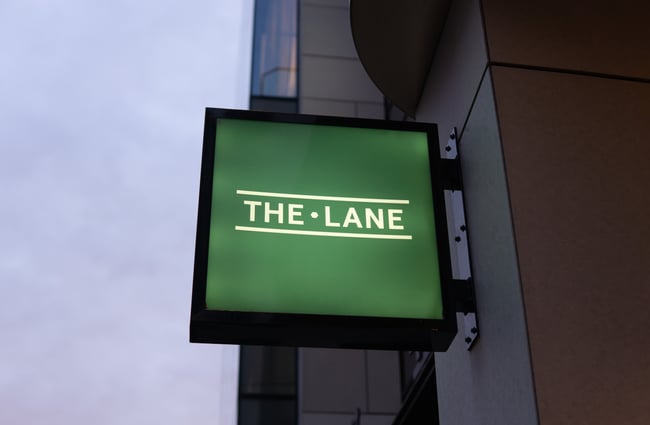 A green 'The Lane' sign.