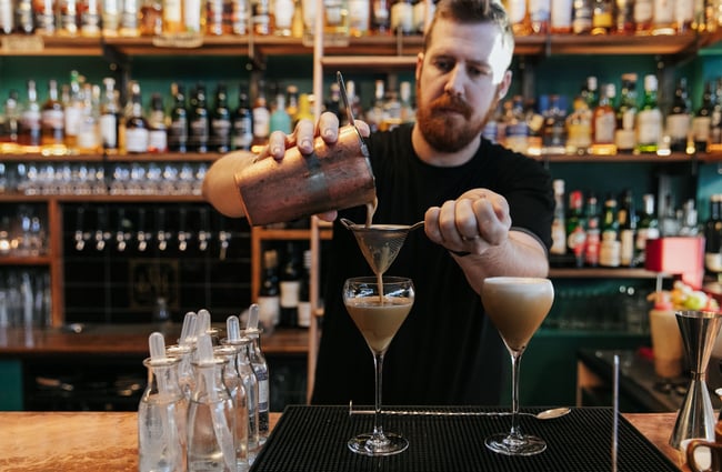 Close up of the barman making a cocktail.