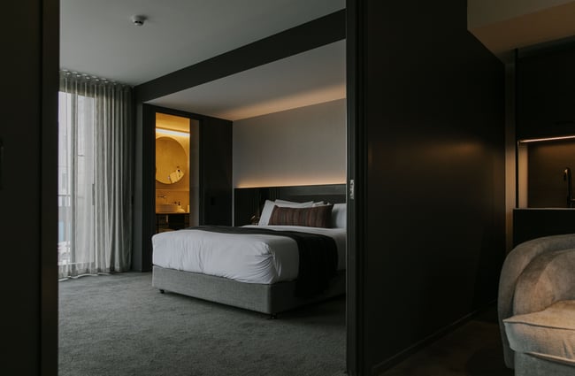 A dark grey and white bedroom inside The Mayfair Christchurch.