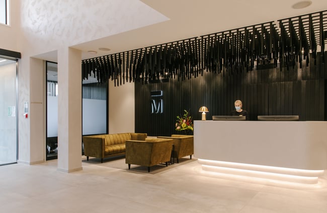 The brightly lit interior of the Mayfair Christchurch hotel reception.