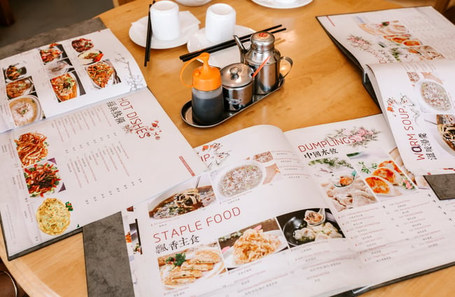 A close up of three menus open on a table.