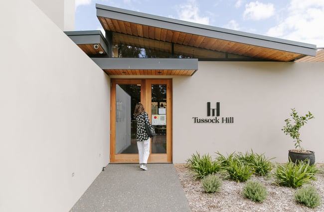 Woman walking into the entrance of Tussock Hill Vineyard, Christchurch.