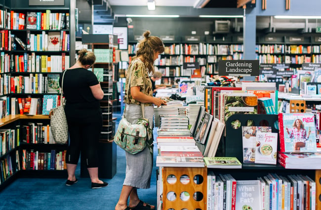 A woman browsing books at the University of Canterbury Bookshop.