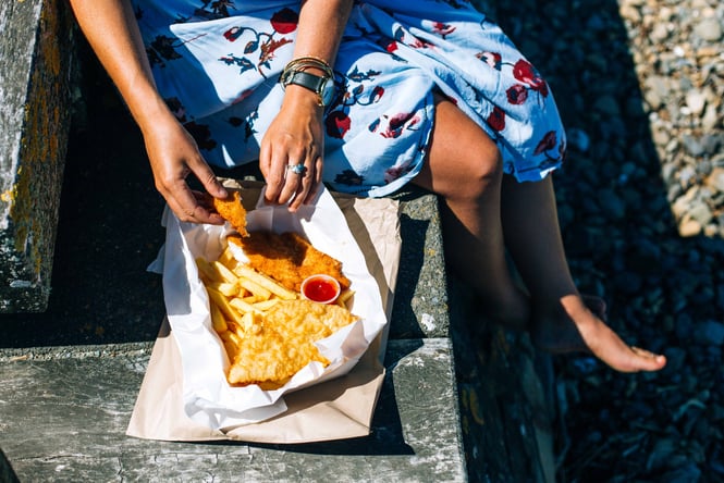 Woman eating fish and chips.