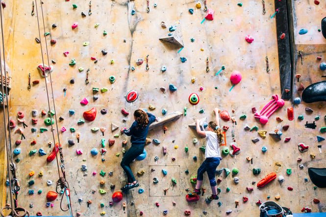 Close up of two girls climbing.