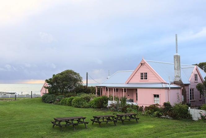 The Fyffe House painted pink on a cloudy day.