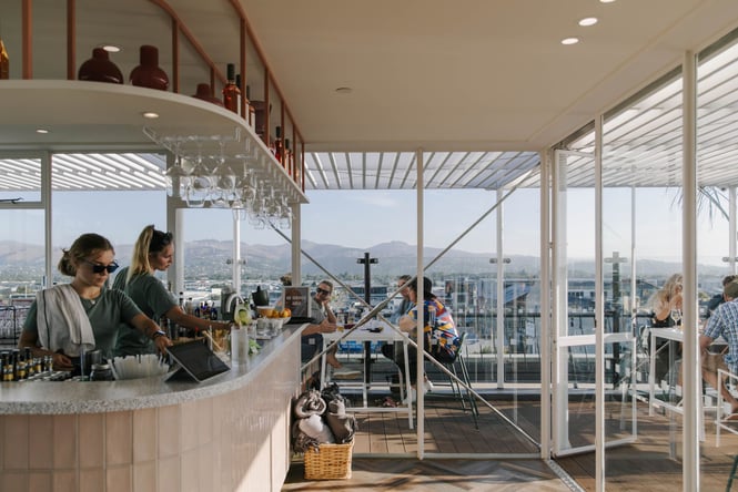The Pink lady rooftop bar where people are enjoying a drink while looking over Christchurch city.