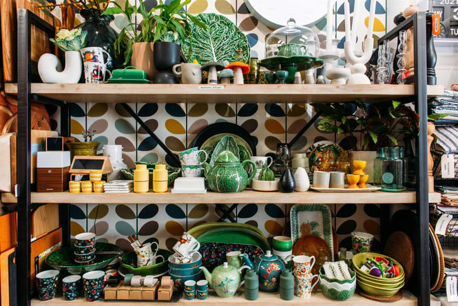 Green and white ceramics on shelves in Cadeaux Havelock North.