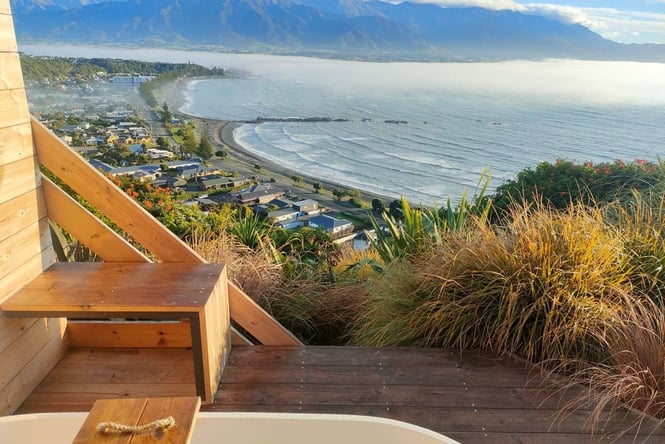 A view of the ocean below from a wooden cabin.