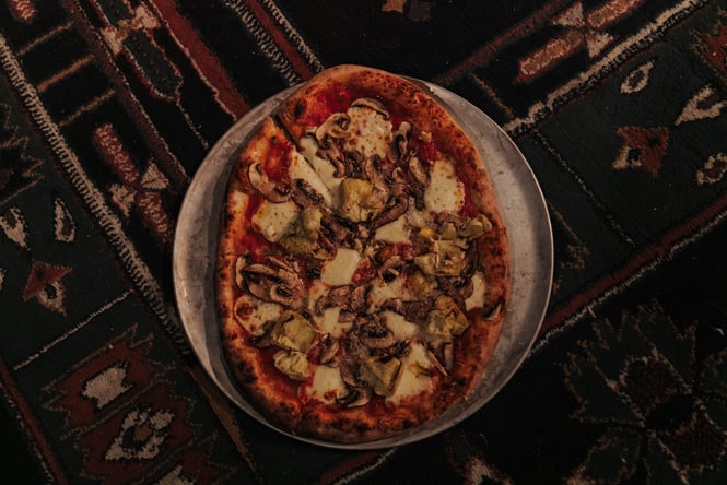 A bird's eye view of a pizza at night.