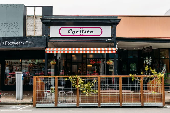 The exterior of Cyclista cafe photographed from across the street in Palmerston North.