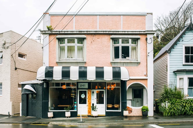 The pink, black and white exterior of Hillside Kitchen on a grey Wellington day.