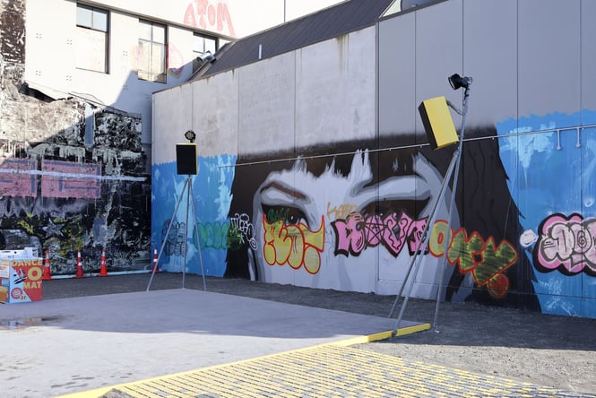 The Dance Mat in Christchurch with a wall covered in graffiti as the backdrop.