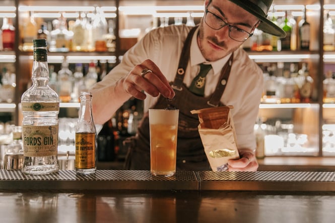 A bar man making a gin cocktail at Austin Club Christchurch.
