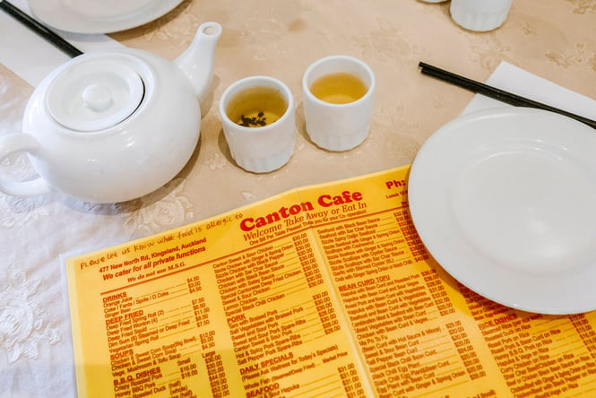 A red and yellow menu on a table.