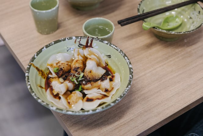 A plate of wontons on a table.