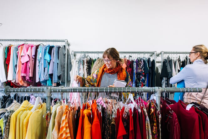 A woman browsing the racks of a vintage store.