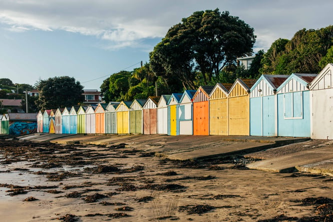 Colourful huts on the beach at sunset.