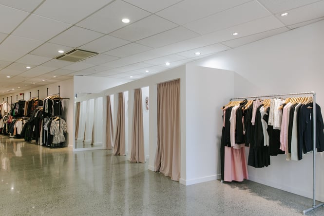 Pink, black and white clothes on display inside the large space of Hyde Boutique.