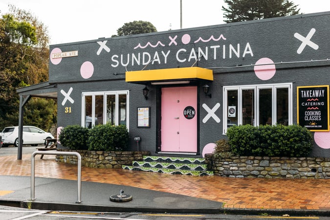 A colourfully decorated building that houses 'Sunday Cantina' cafe.