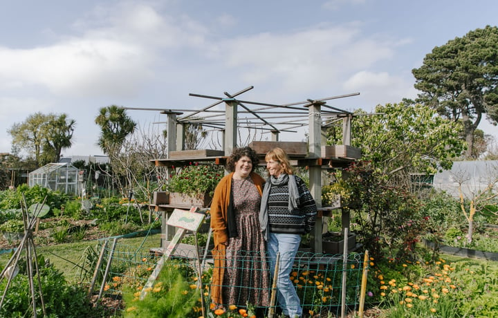 Catherine O’Neill and Lin Klenner smiling in their New Brighton Community Gardens.