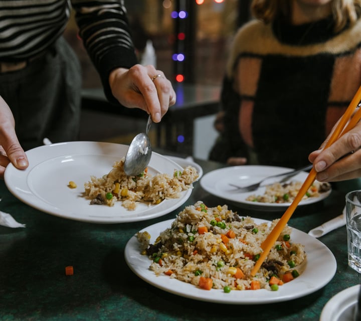 Close up of customers serving themselves fried rice.