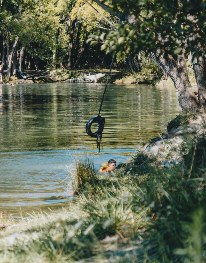A boy swimming in a lake.
