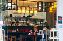 Two customers at a table in Garden Place Noodle Bar, Hamilton.