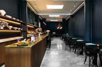 The dark interior of Hastings Distillers with walls painted a deep blue.