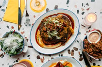 A flat lay of delicious looking plates of food on a table.