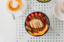 A flatly of a breakfast bowl on a white table.