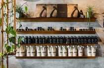Real World bottles and refill pouches on display on floating shelves.