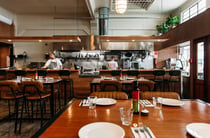Two chefs working inside the open kitchen at Sazio in Hastings.