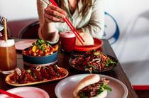A woman holding chopsticks.