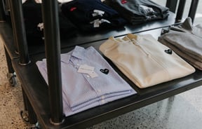 Close up of CDG play shirts at PLUME.