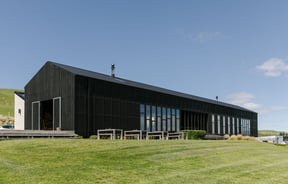 The exterior of the Black Estate building on a sunny day.