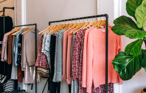 Pink clothes on racks.